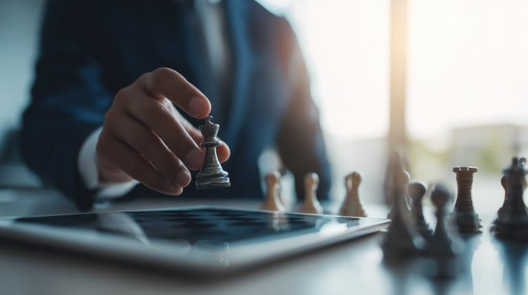 man in a business suit holding a chess piece