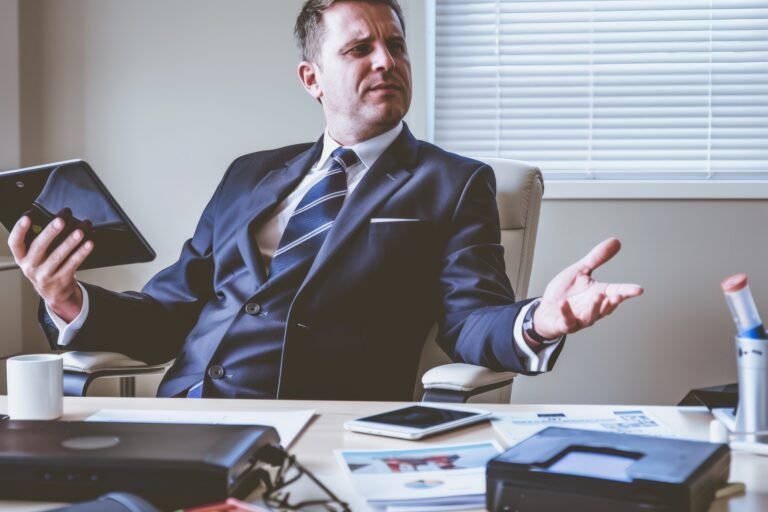 Businessman in Suit, Excitedly Presenting on Tablet