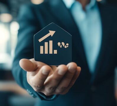 person-is-holding-black-houseshaped-object-with-growing-bar-graph-another-symbol-it