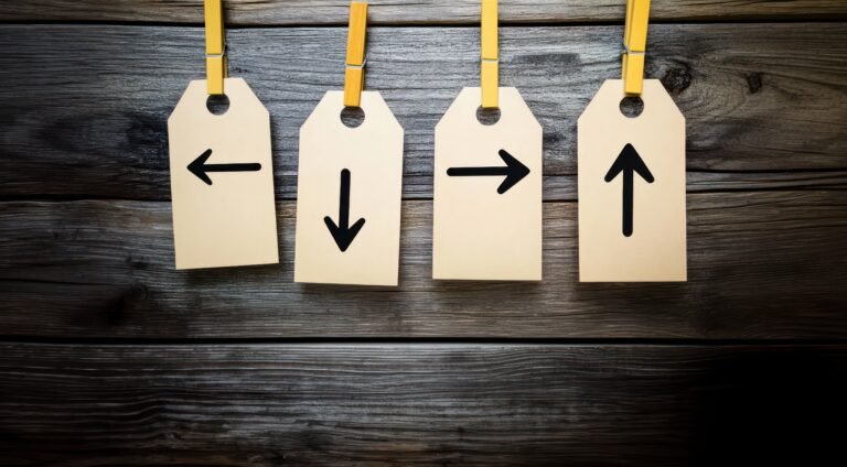 Four empty beige rectangular tags with black arrows hanging from