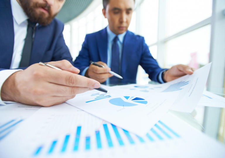 Close-up businessmen working together with diagrams