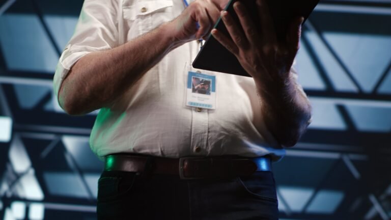 Close up shot of focused specialist expertly managing data while navigating through industrial server rigs. Organized manager ensuring proper cybersecurity protection, optimizing systems, close up